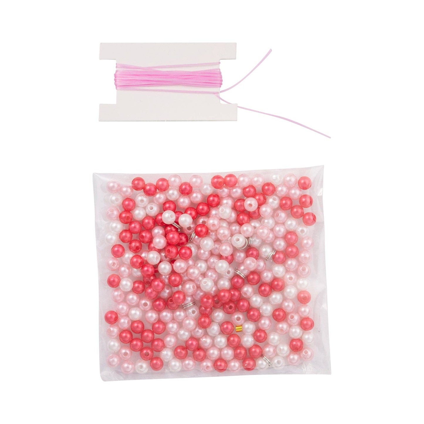 Bag of pink and white beads with a spool of thread on a white background