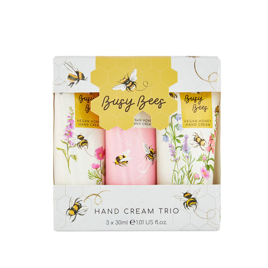 Three multi-colored tubes of hand cream in a white box with multi-colored bees