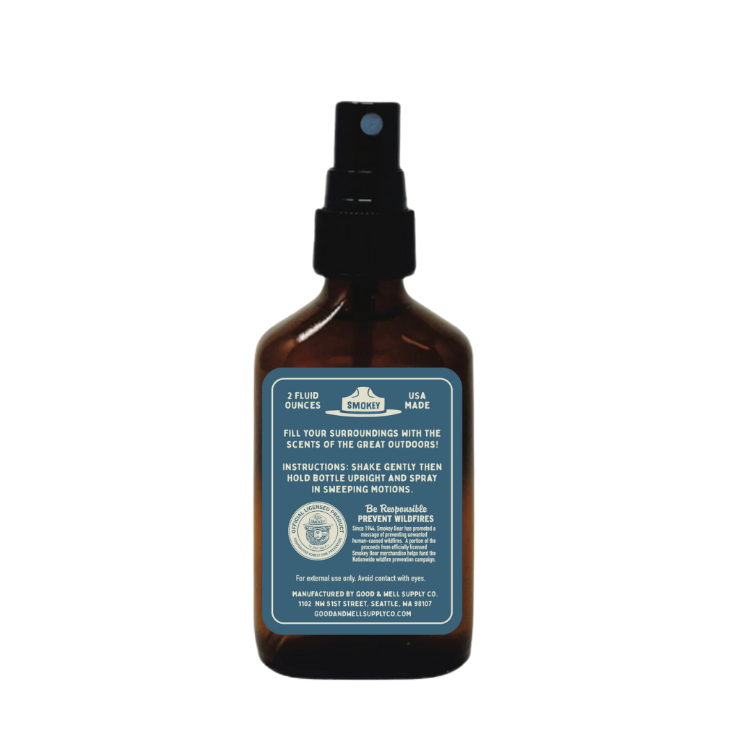 Brown spray bottle with a blue label on a white background