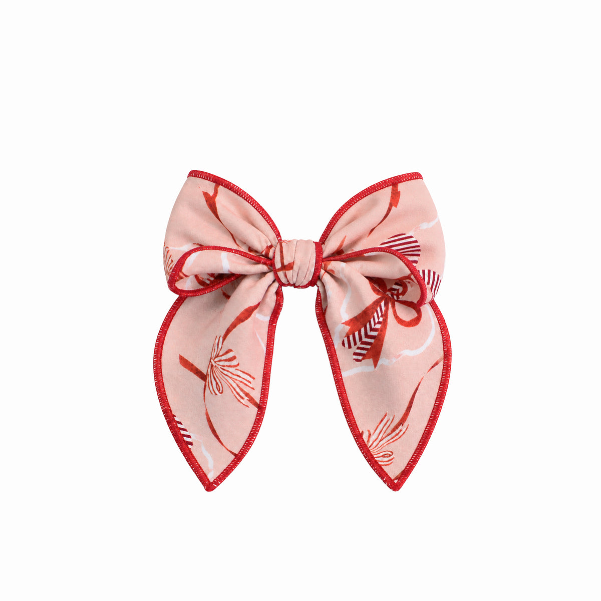 A pink hair bow accessory with a red patterned silk-like fabric and a red stitched border, shown against a plain white background.