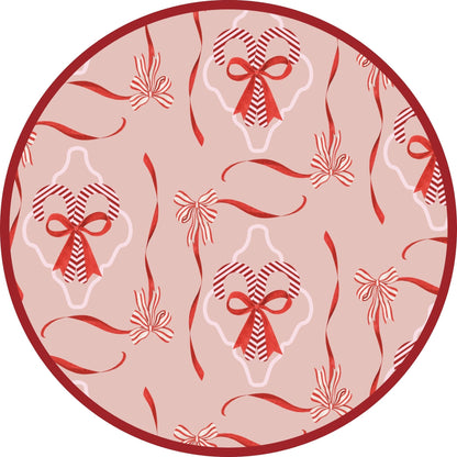 Close-up of Candy Cane Coquette print featuring red bows and festive illustrations on a soft pink background.