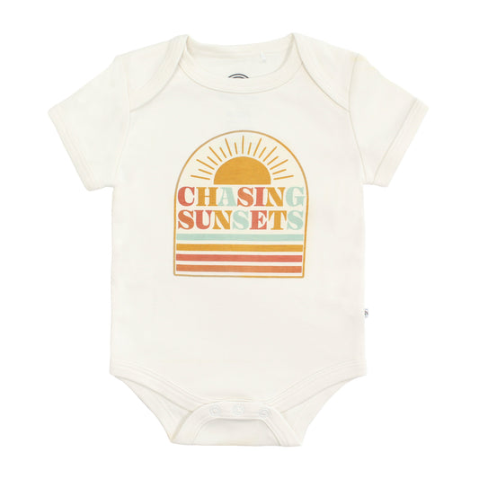 Baby bodysuit with 'Chasing Sunsets' design on a white background