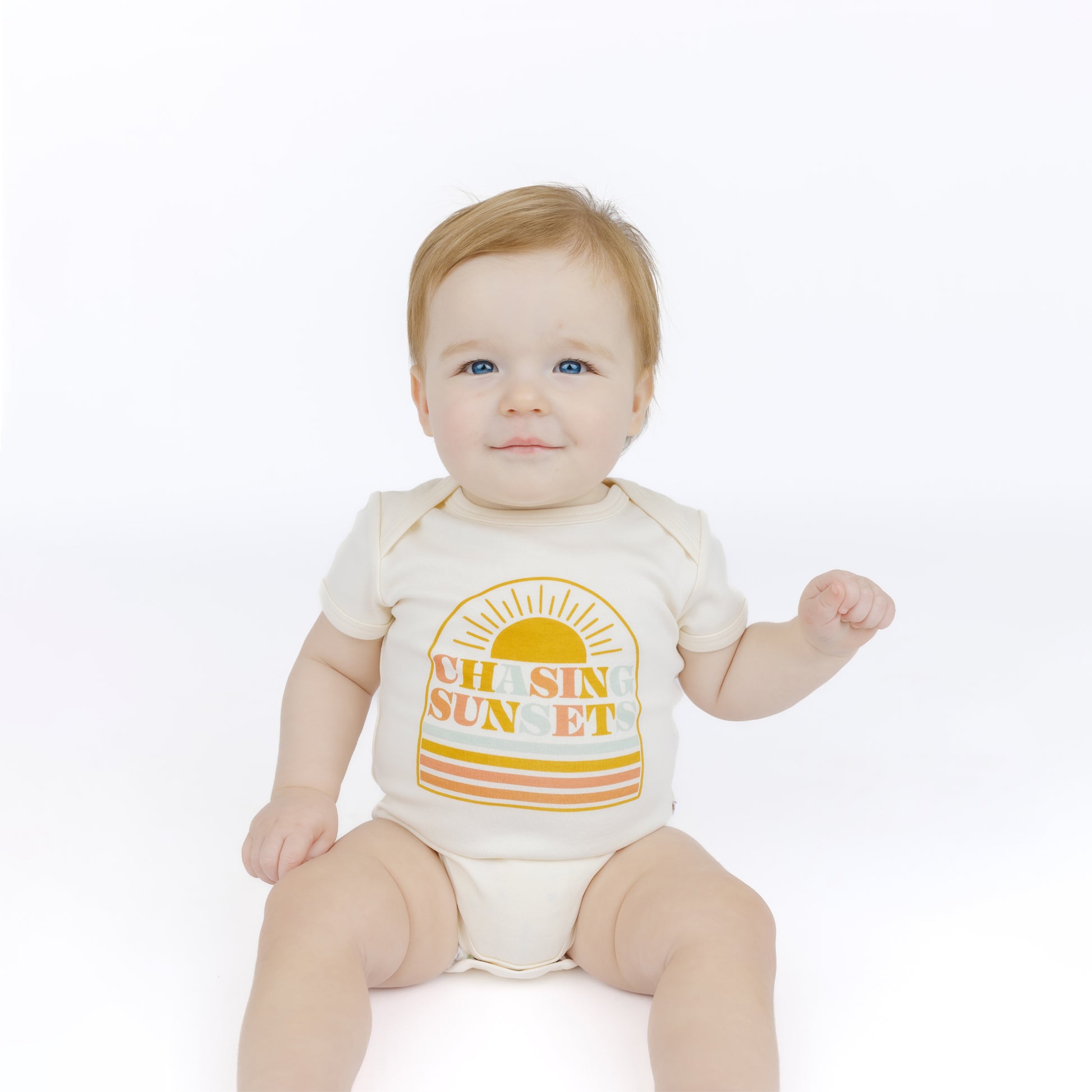 Baby wearing a bodysuit with 'Oh Sun Sunset' design on a white background