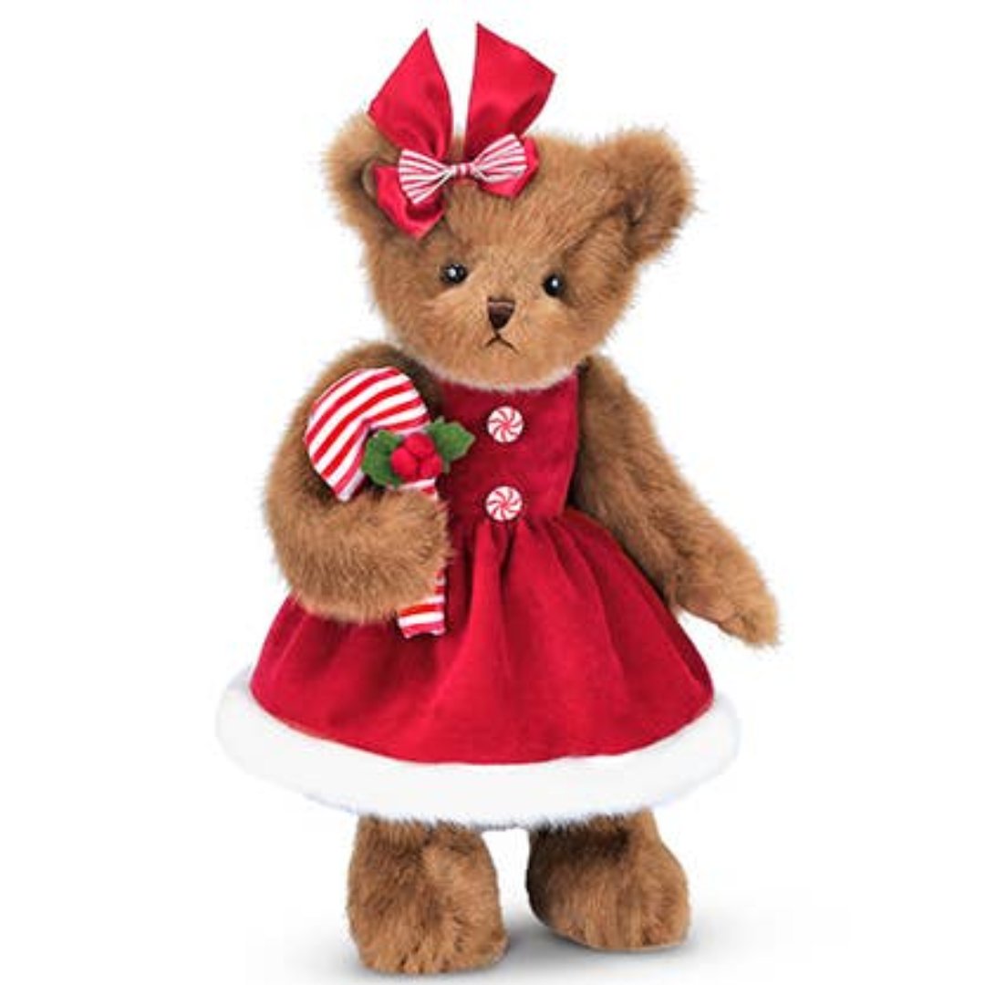 bear plush stuffed animal in a red dress and red bowtie with a candy cane in hand