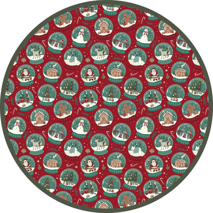 Close-up of festive Christmas pajama print featuring holiday illustrations on a green background.
