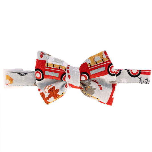 the "christmas train" bamboo pet bow-tie. the "christmas train" pattern has various winter character that stand/ride on a red train. these characters include: santa, santa's elves, raindeers, yeti monsters, gingerbreads, reindeer, christmas trees, candy canes, presents, and snowflakes.  