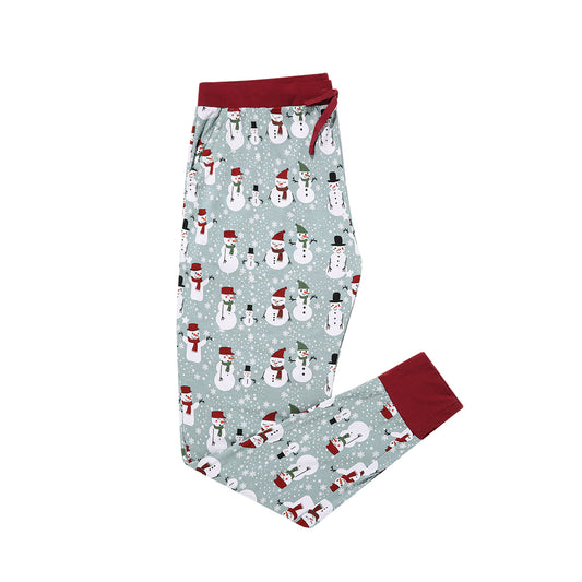 the "snow people" women's jogger pajama pants. the "snow people" print is a winter wonderland themed style. there are snowflakes and snowmen scattered around a cute green/blue/grey background.