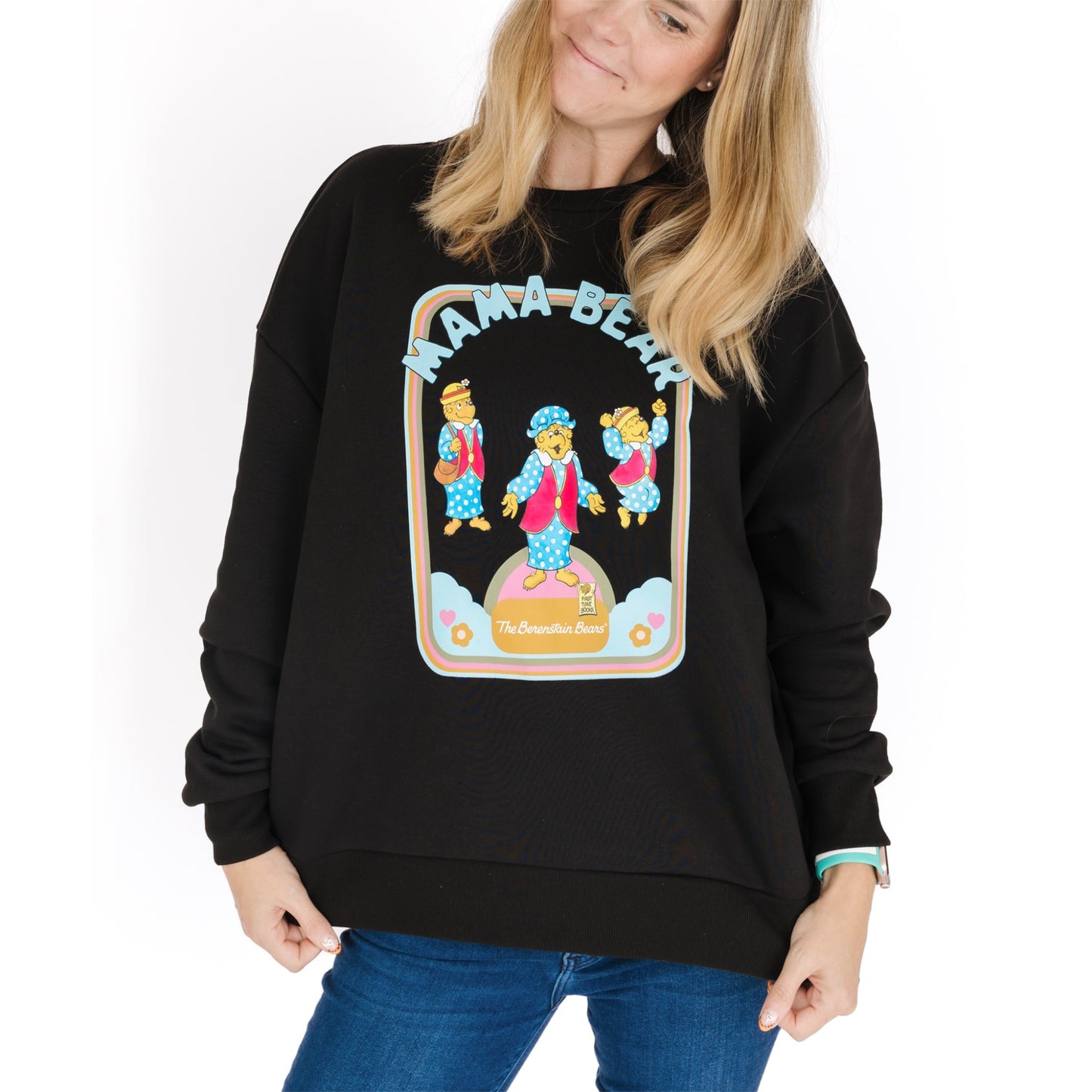 Black sweatshirt with 'Mama Bear' graphic design worn by a person on a white background