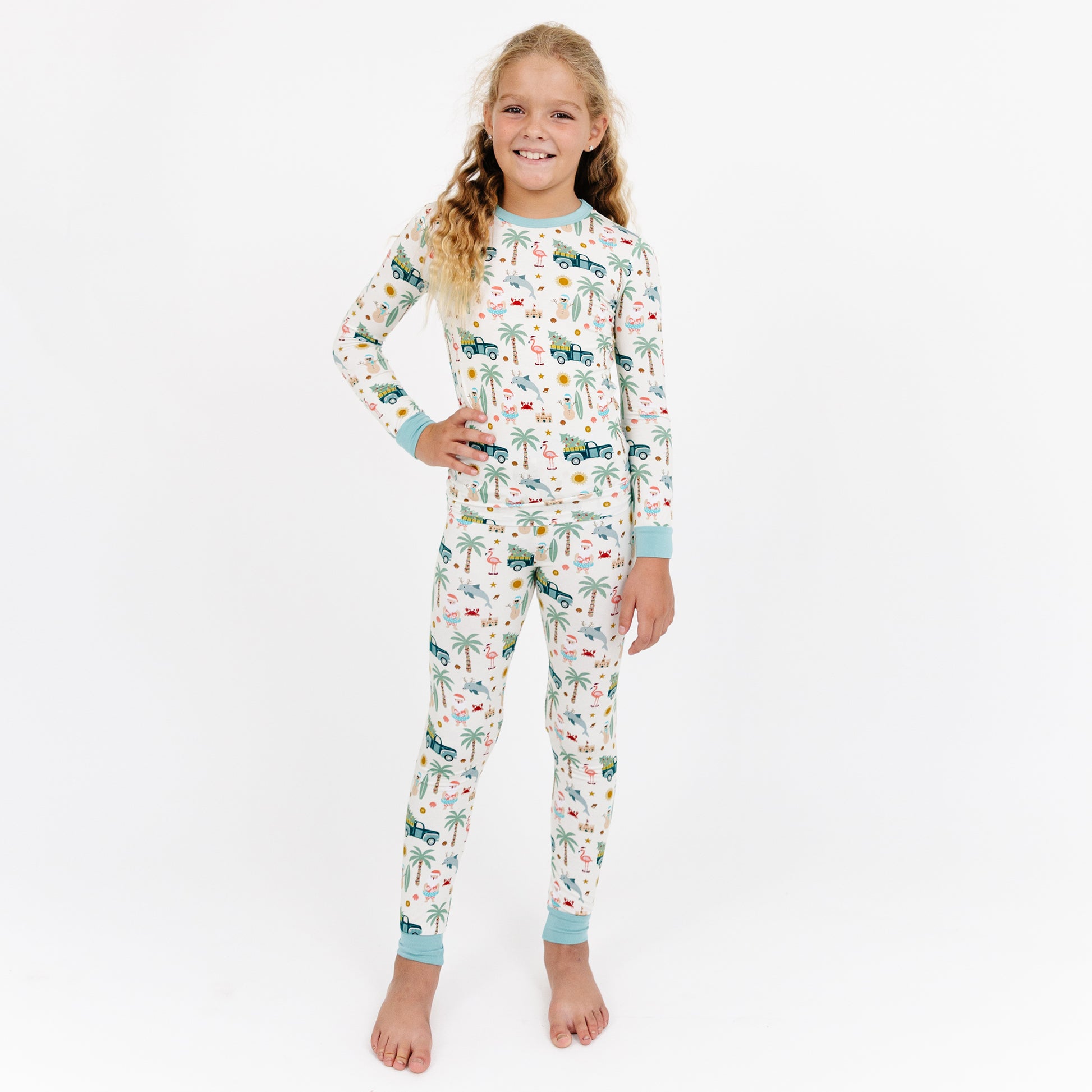 Child wearing a patterned onesie on a white background