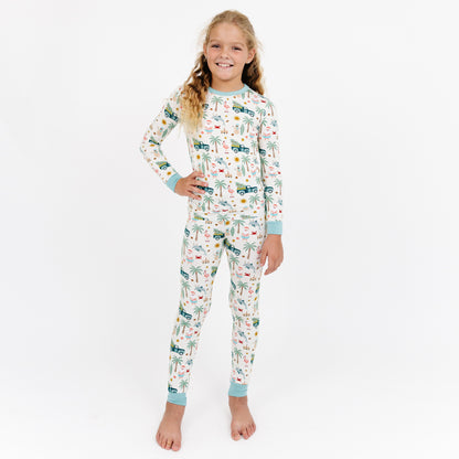 Child wearing a patterned onesie on a white background