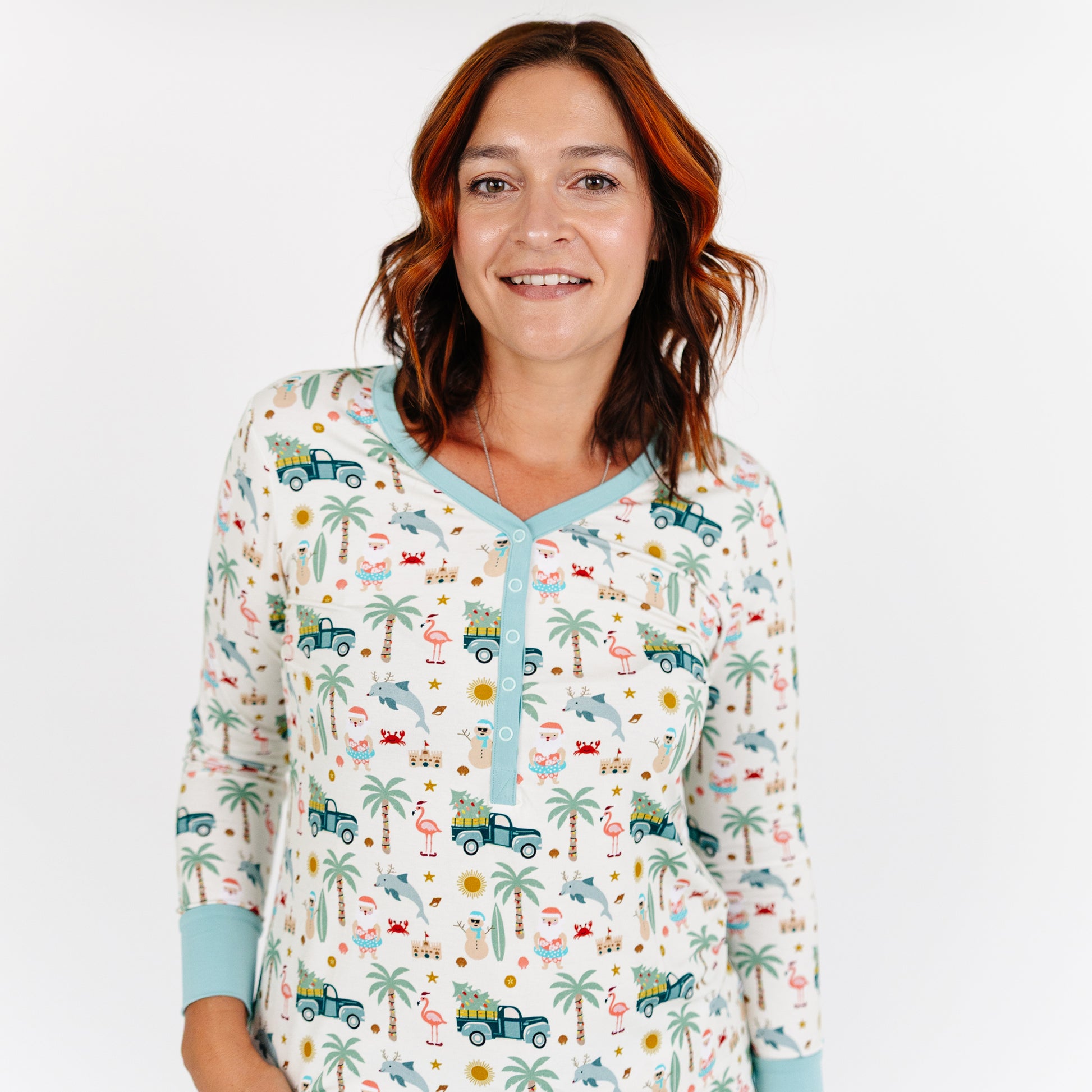 Woman wearing a patterned pajama top with a white background