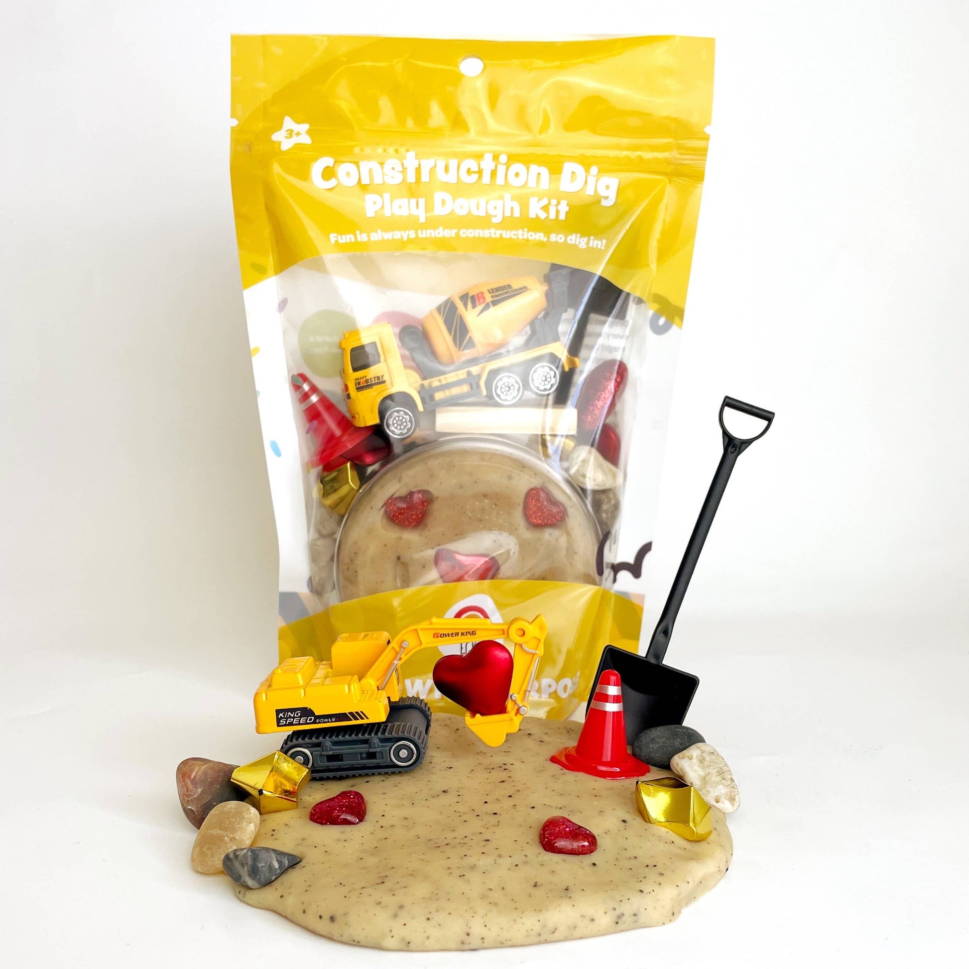 Construction-themed play dough kit with toys and packaging on a white background