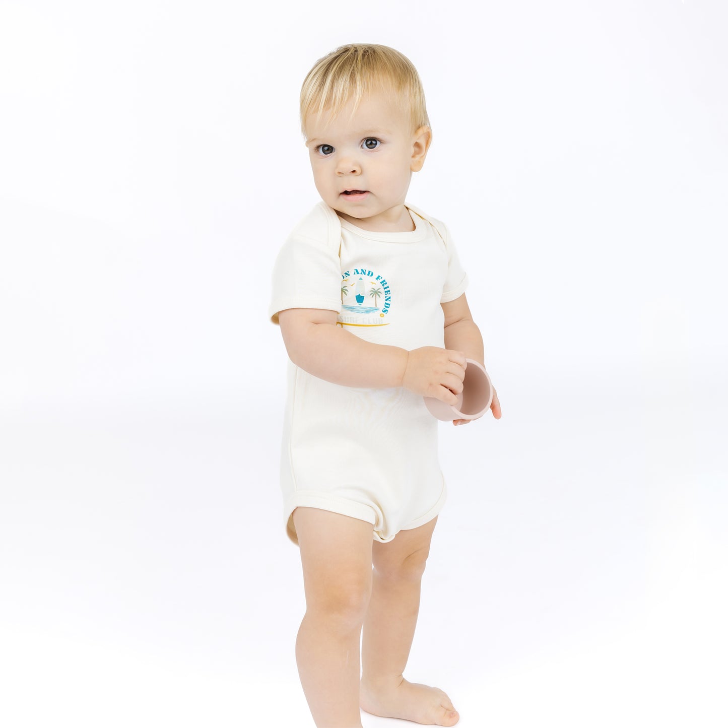 Baby wearing a white bodysuit with a blue graphic and text on a white background