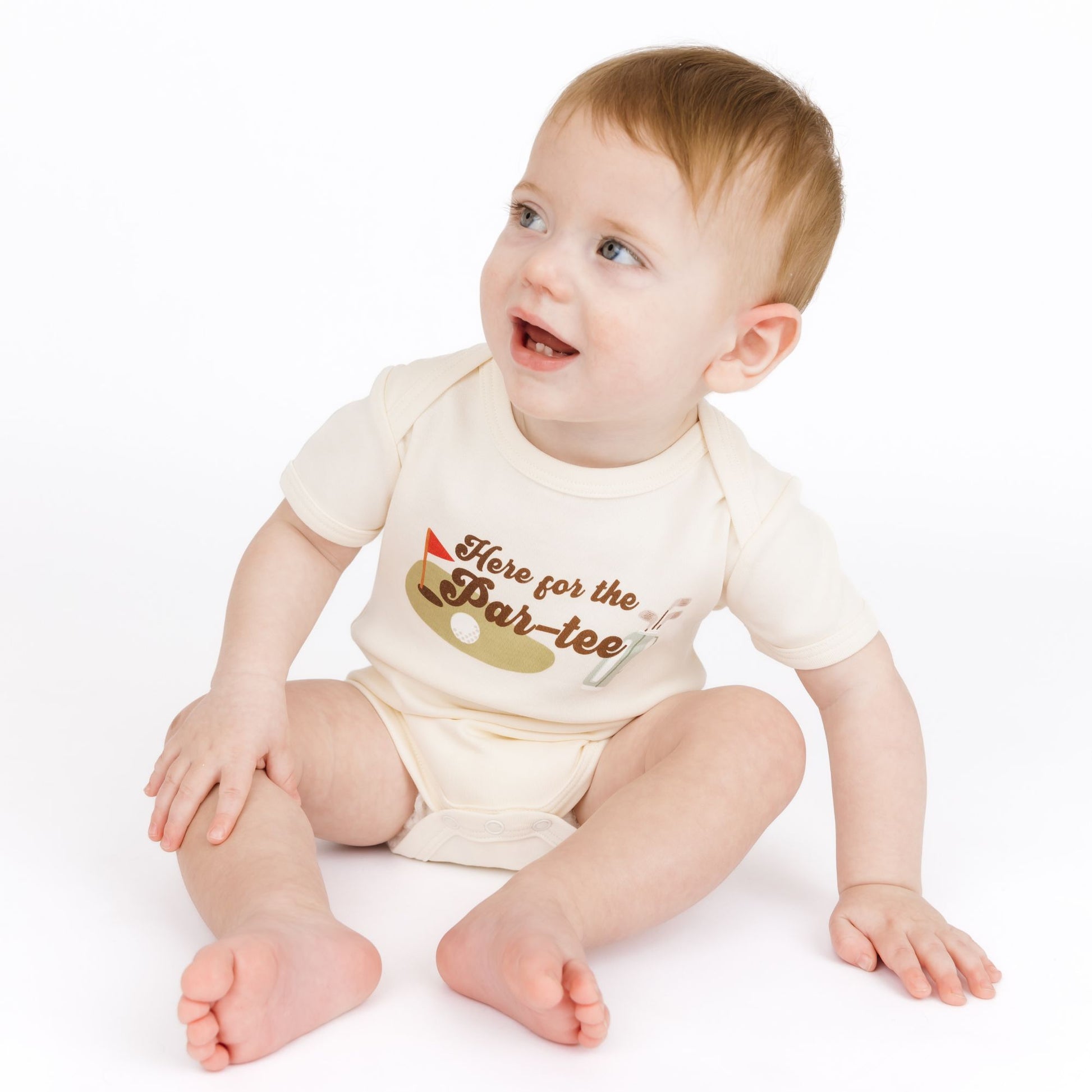 Baby wearing a onesie with text and graphics on a white background