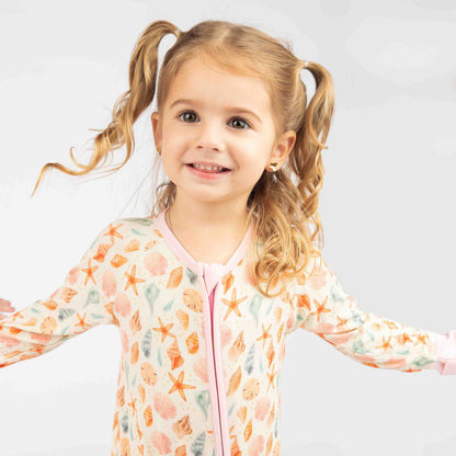 Baby girl wearing the Sandy Seashell convertible bamboo pajama. 