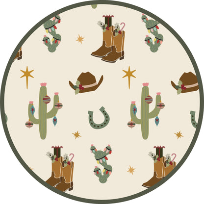 Close-up of Cowboy Christmas print featuring cowboy boots, cacti, horseshoes, and festive Western illustrations on a cream background.