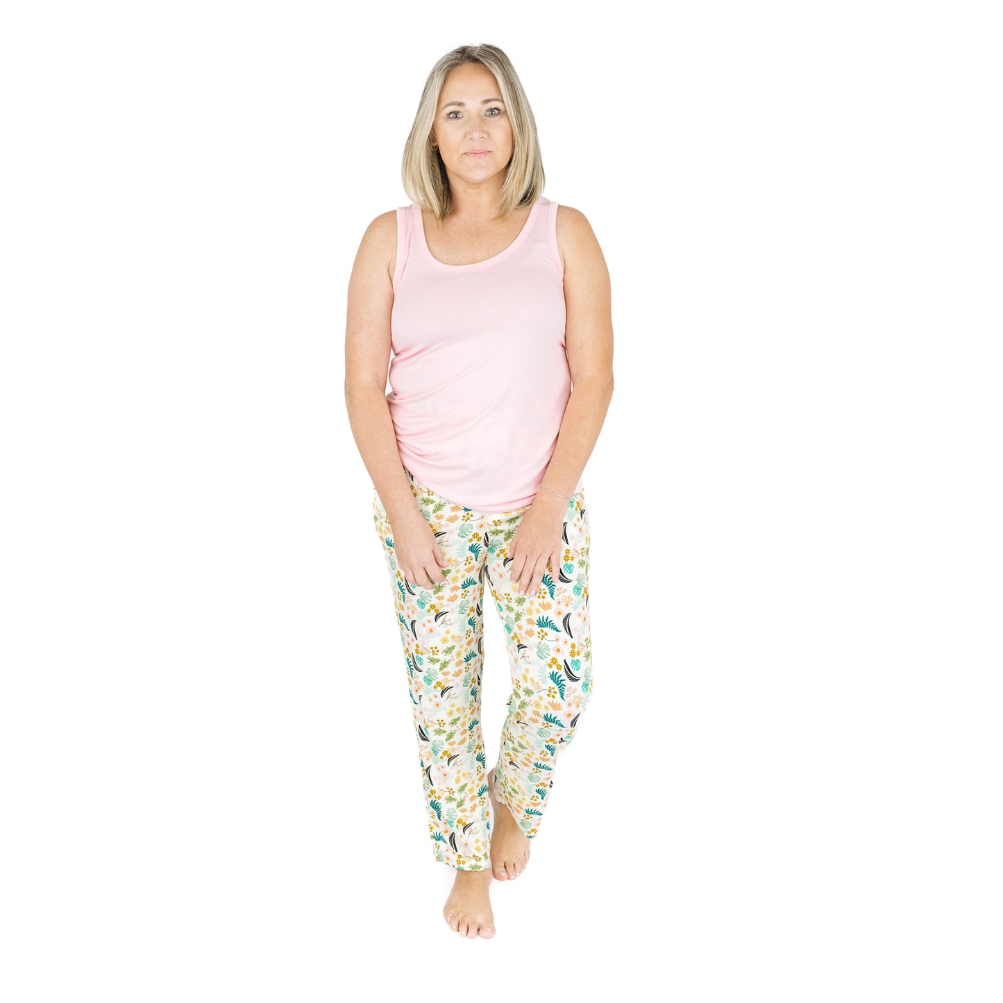 Model sitting comfortably in the Tropical Blooms botanical print lounge pants, highlighting the buttery-soft bamboo fabric.