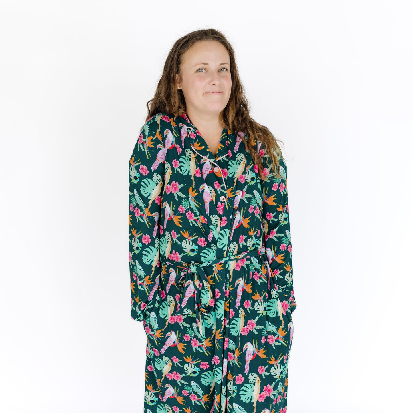 Close-up of a woman in the Isla Botánica robe, showing the premium quality and trendy in-house tropical bird design.