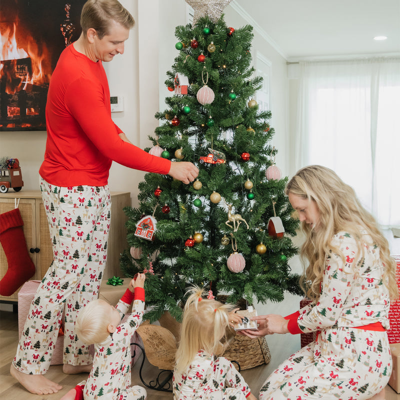 Family decorates the Christmas tree wearing Cozy Christmas bamboo lounge pants, showcasing soft fabric and festive design.