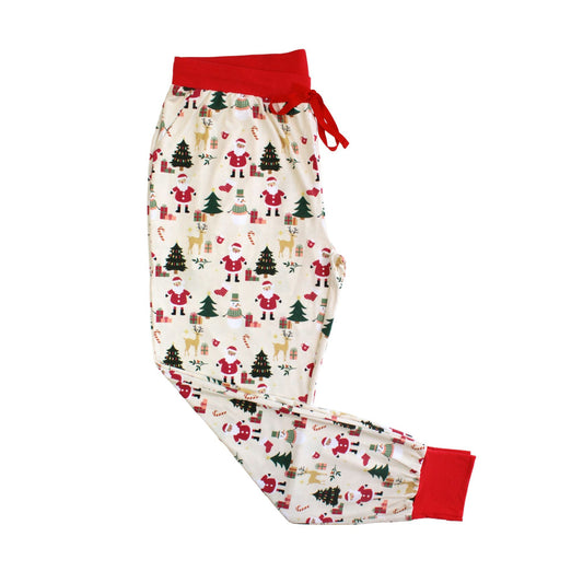 Flat lay of Cozy Christmas bamboo women’s jogger pajama pants with red cuffs and festive holiday print featuring Santa and trees.
