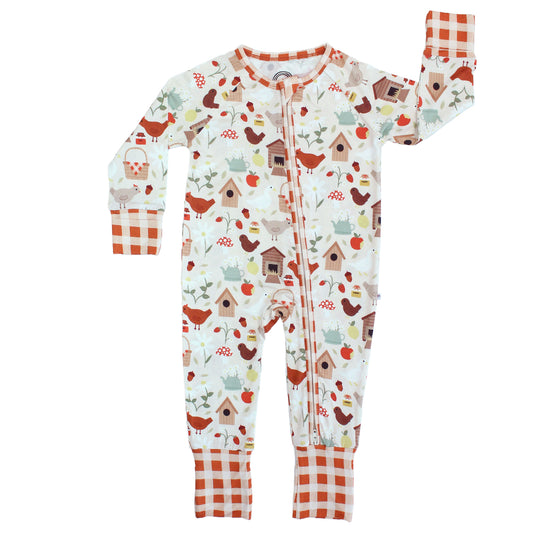 Emerson and Friends Cozy Cottage Bamboo Convertible Baby Pajamas, featuring a soft farmhouse-inspired print with chickens, birdhouses, and apples, fold-over cuffs, and a two-way zipper for easy diaper changes.