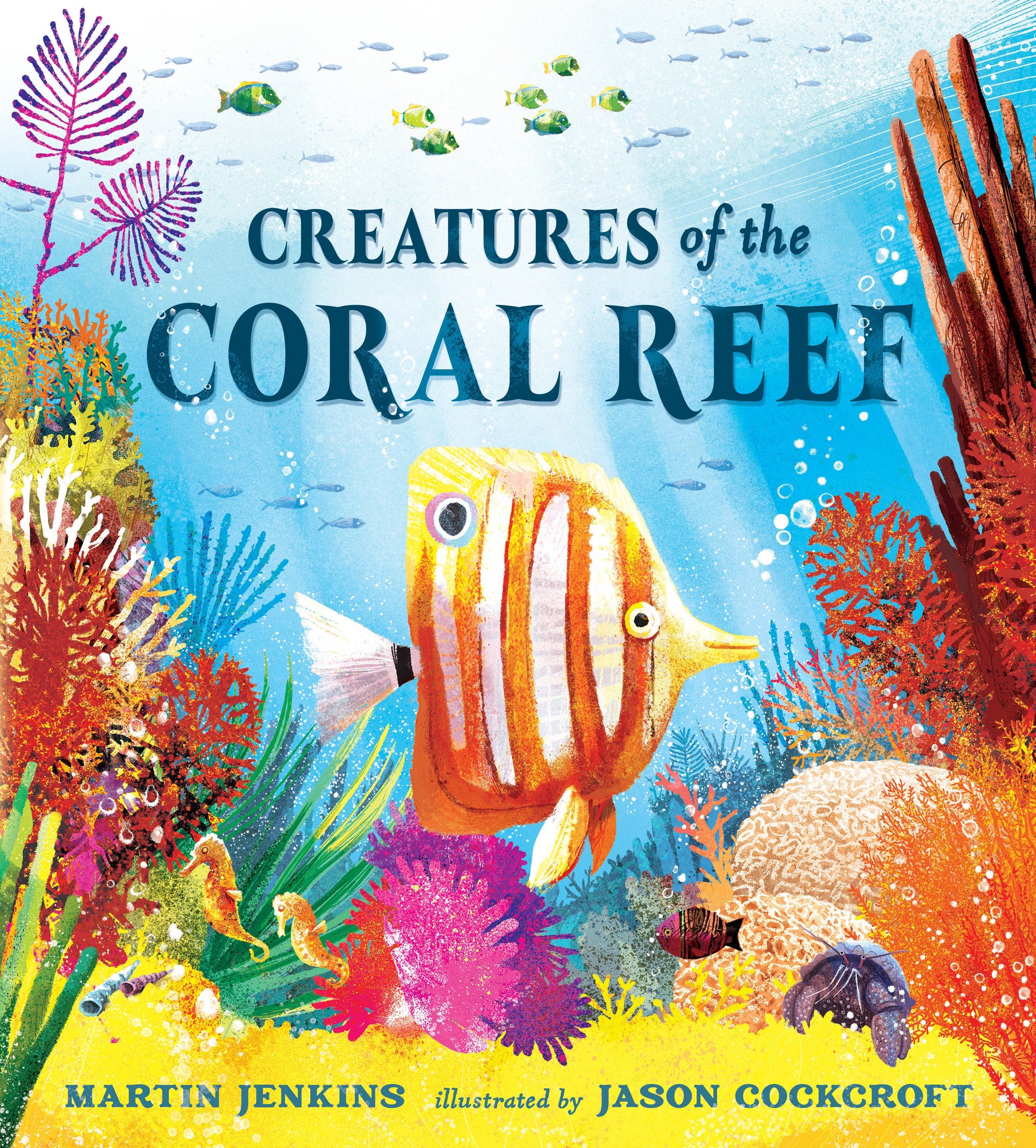 Book cover of 'Creatures of the Coral Reef' with colorful fish and coral illustration.