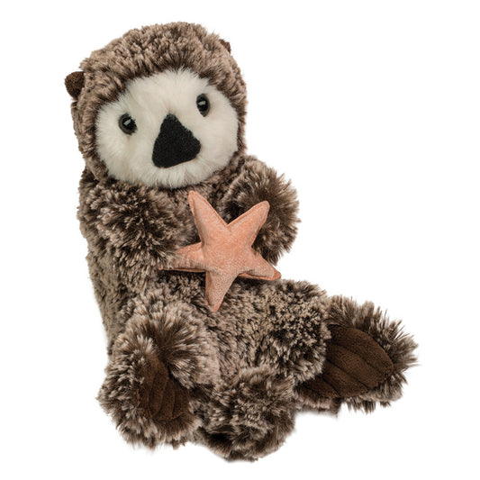 Plush otter toy holding a starfish on a white background