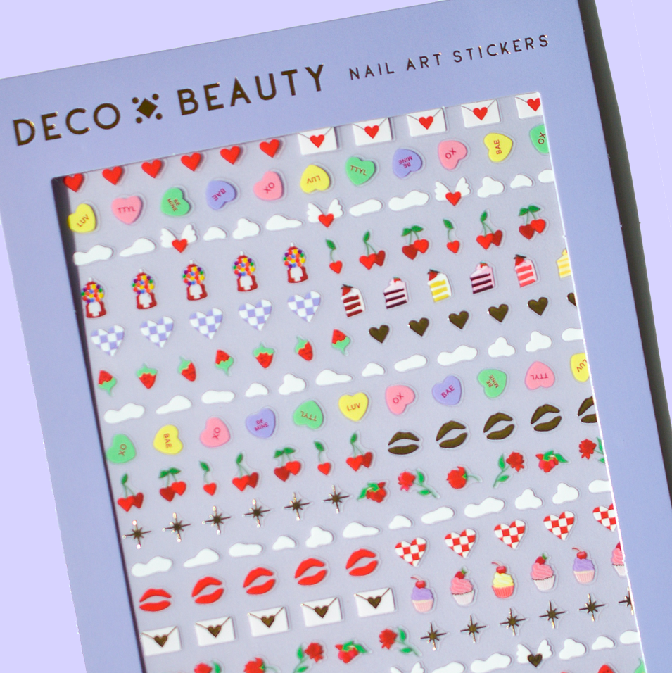 Sheet of nail art stickers with various designs on a purple background