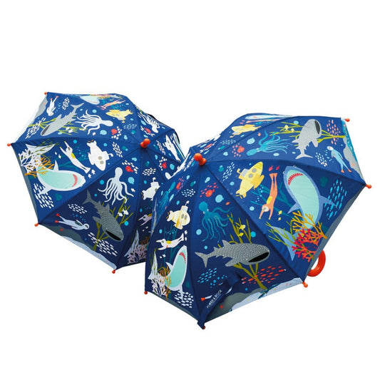 Two blue umbrellas with images of ocean animals, divers, and submarines