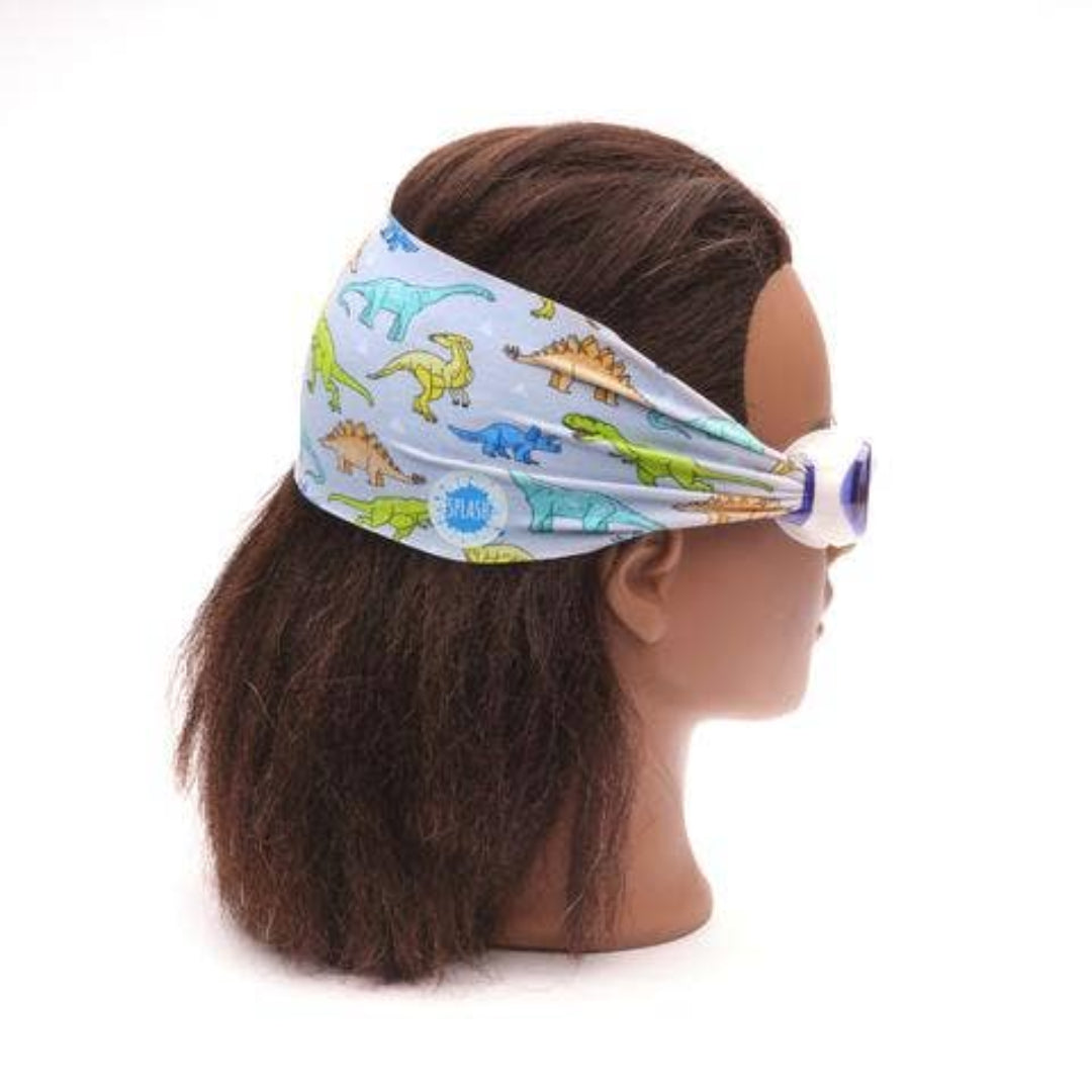 blue goggles with a thick fabric back strap  that has dinosaurs on it
