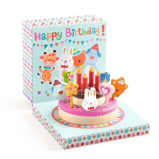 Children's birthday cake with animal toppers and candles on a colorful box