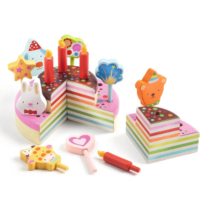 Colorful toy birthday cake set with candles and decorations on a white background