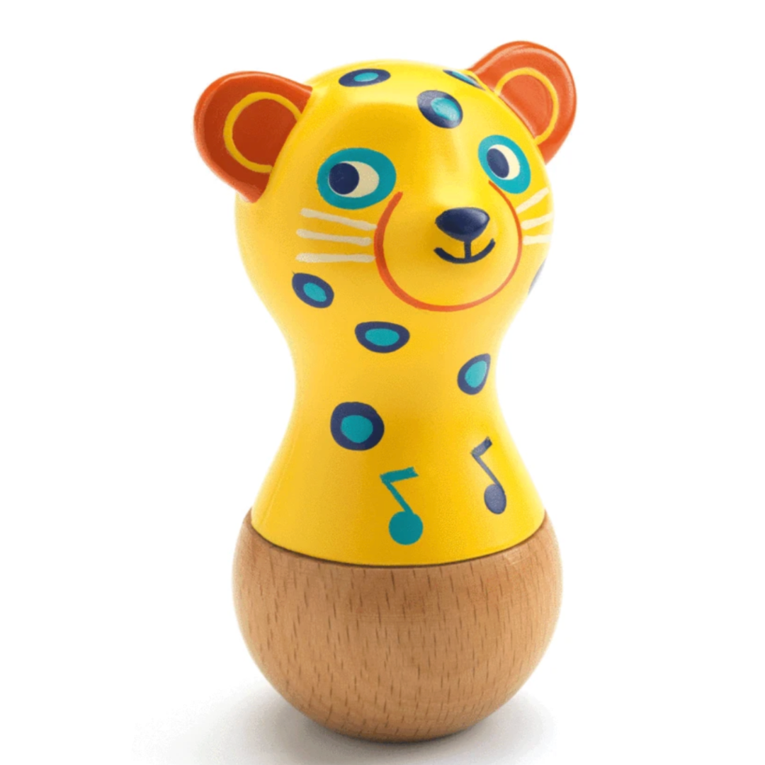 a baby rattle maraca thats shaped like a jaguar head and is yellow with blue spots and a smile on the face