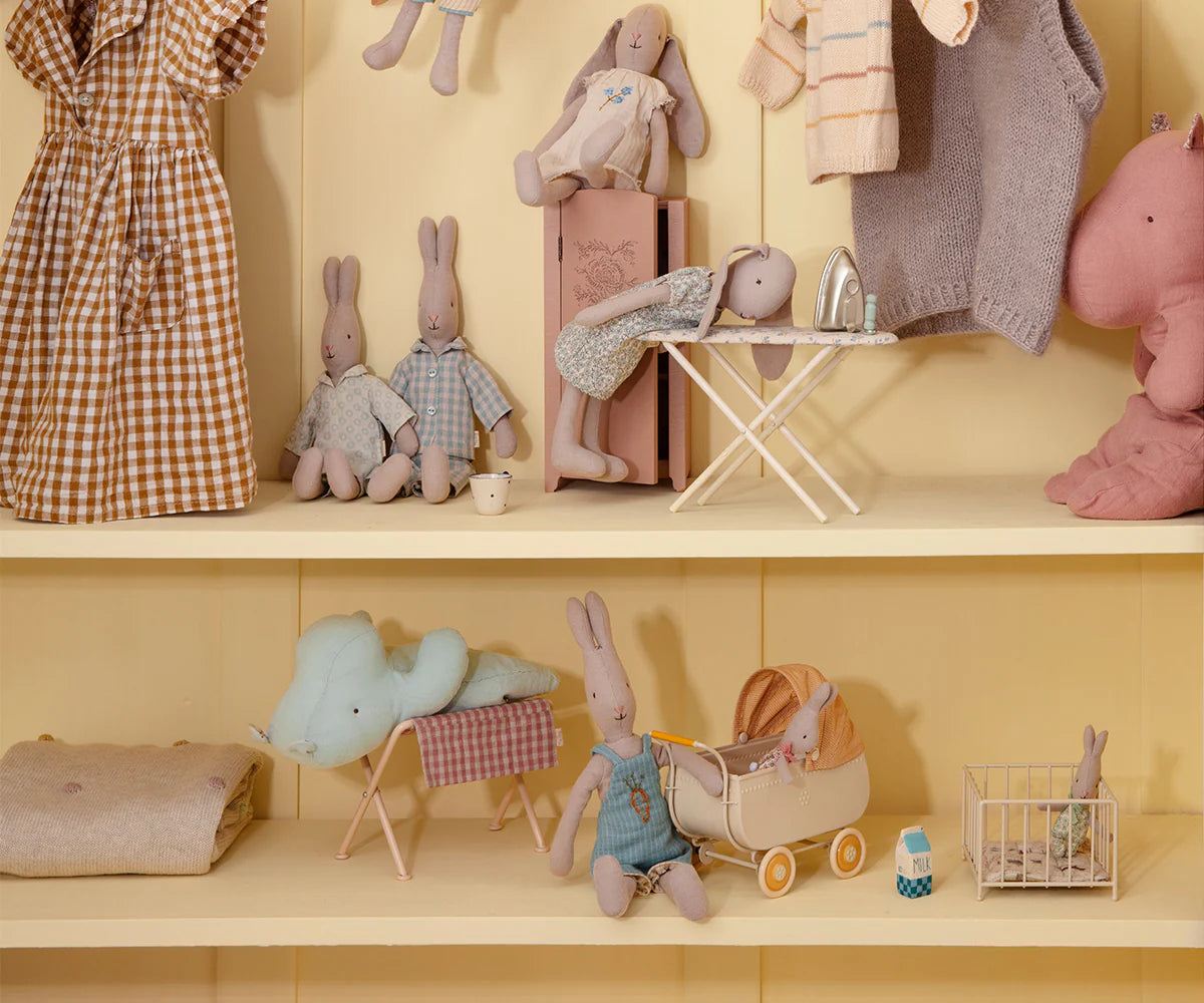 Shelves with stuffed animals and toys on a yellow background