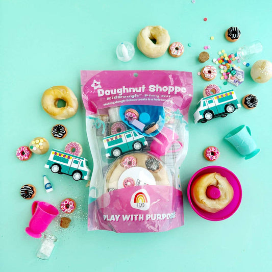 Doughnut-themed playset with toys and packaging on a teal background
