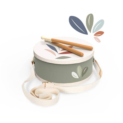 Children's drum with leaf design and two wooden sticks on a white background