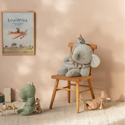 Children's room with plush toys and a framed picture on the wall.