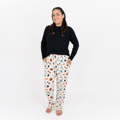 Woman wearing Emerson and Friends Hat Trick bamboo lounge pants with hockey print.