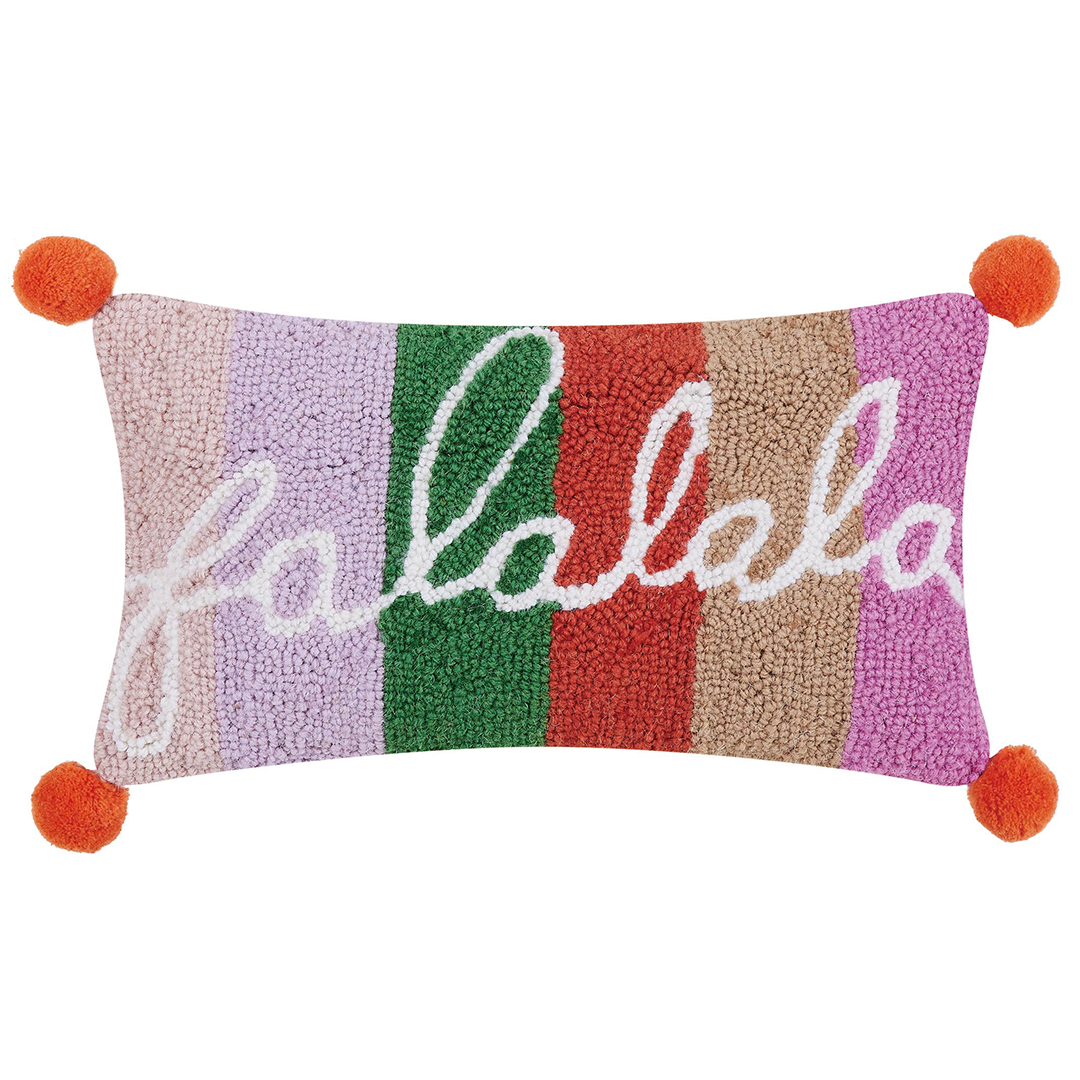 multi colored pillow that says FALALA on it with red pom poms