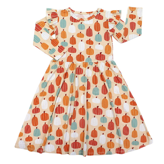 the "pumpkin patch" long-sleeve twirl dress. the 'pumpkin patch" print is a mix of boho styled and colored pumpkins. you can see white, blue, orange, and red pumpkins in.different shapes and sizes. this is all on a pastel orange background. 