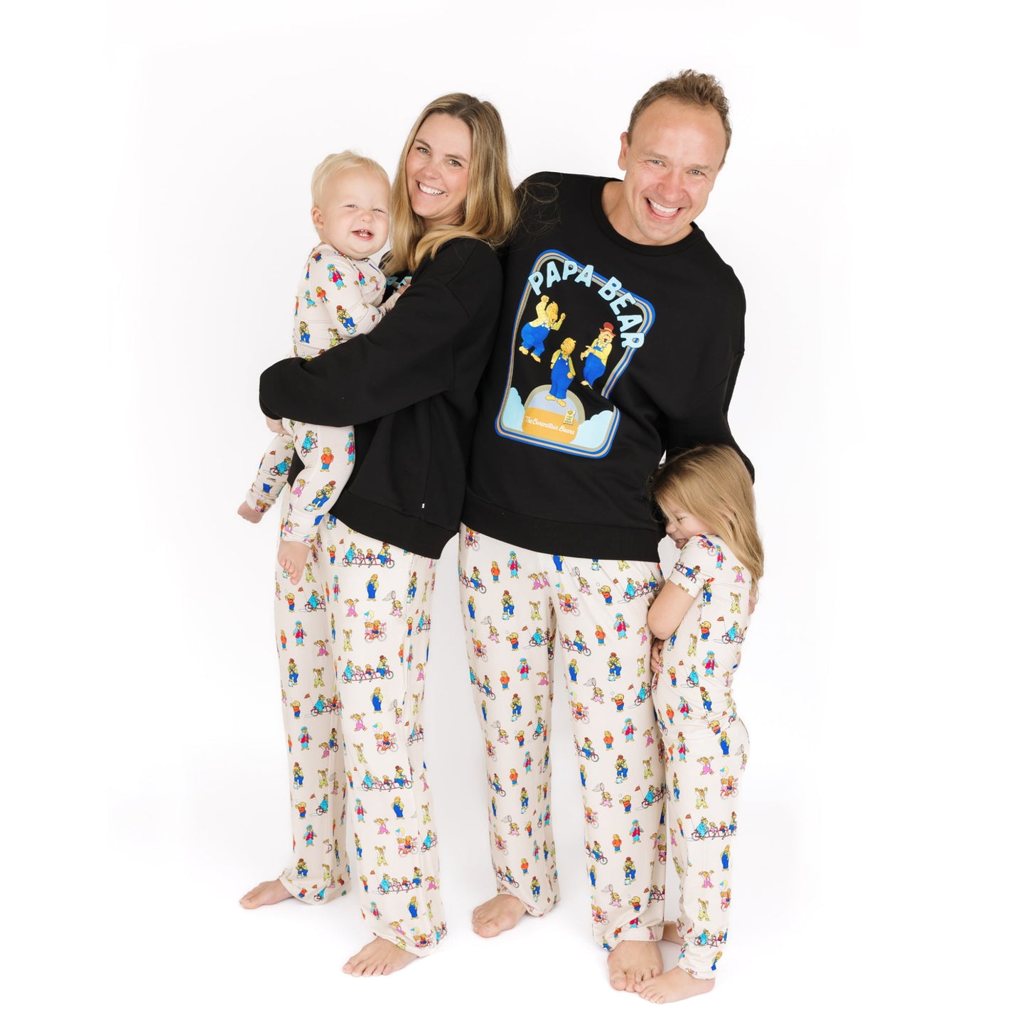 Family of four wearing matching pajamas with a white background