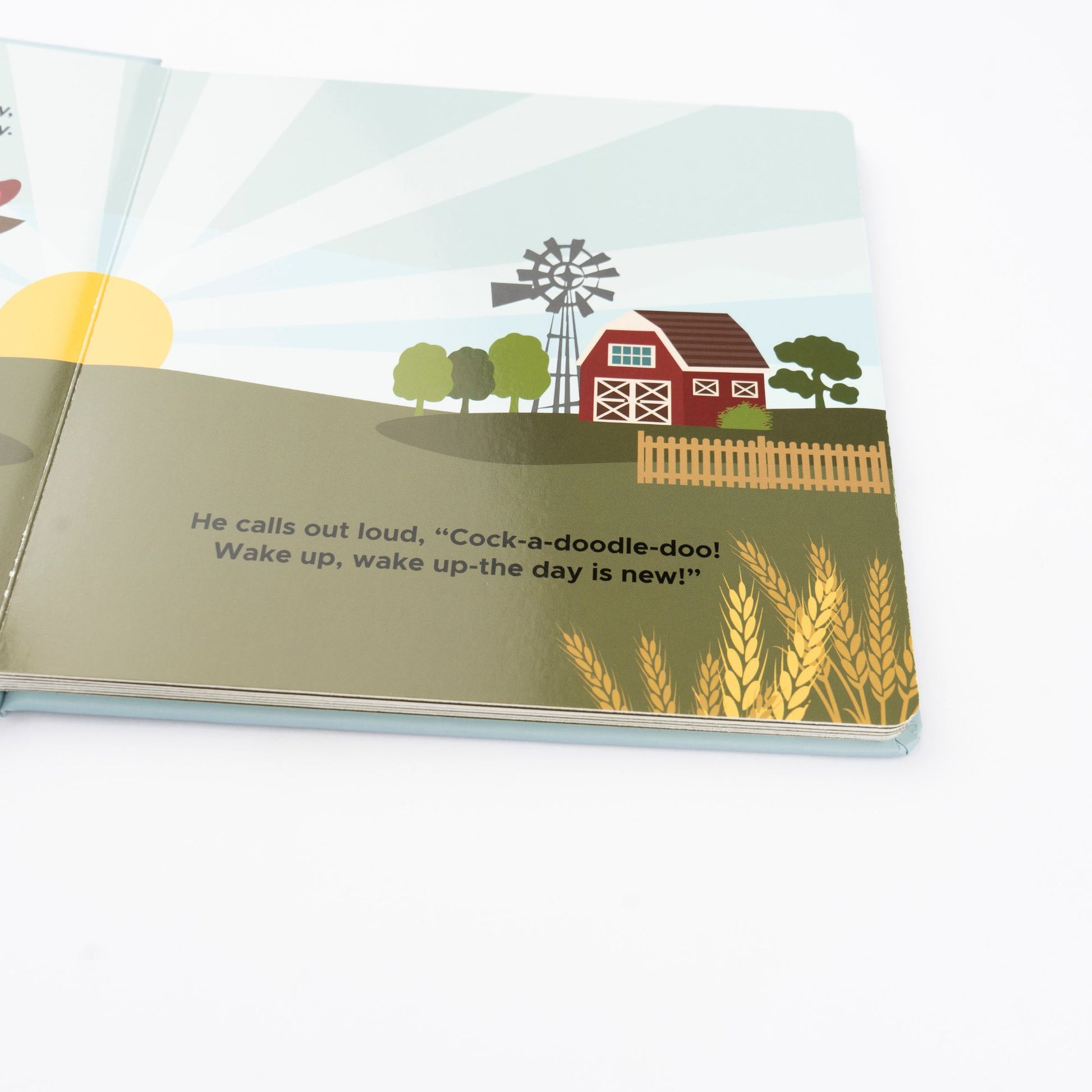 Illustrated book page with a farm scene, windmill, and text.