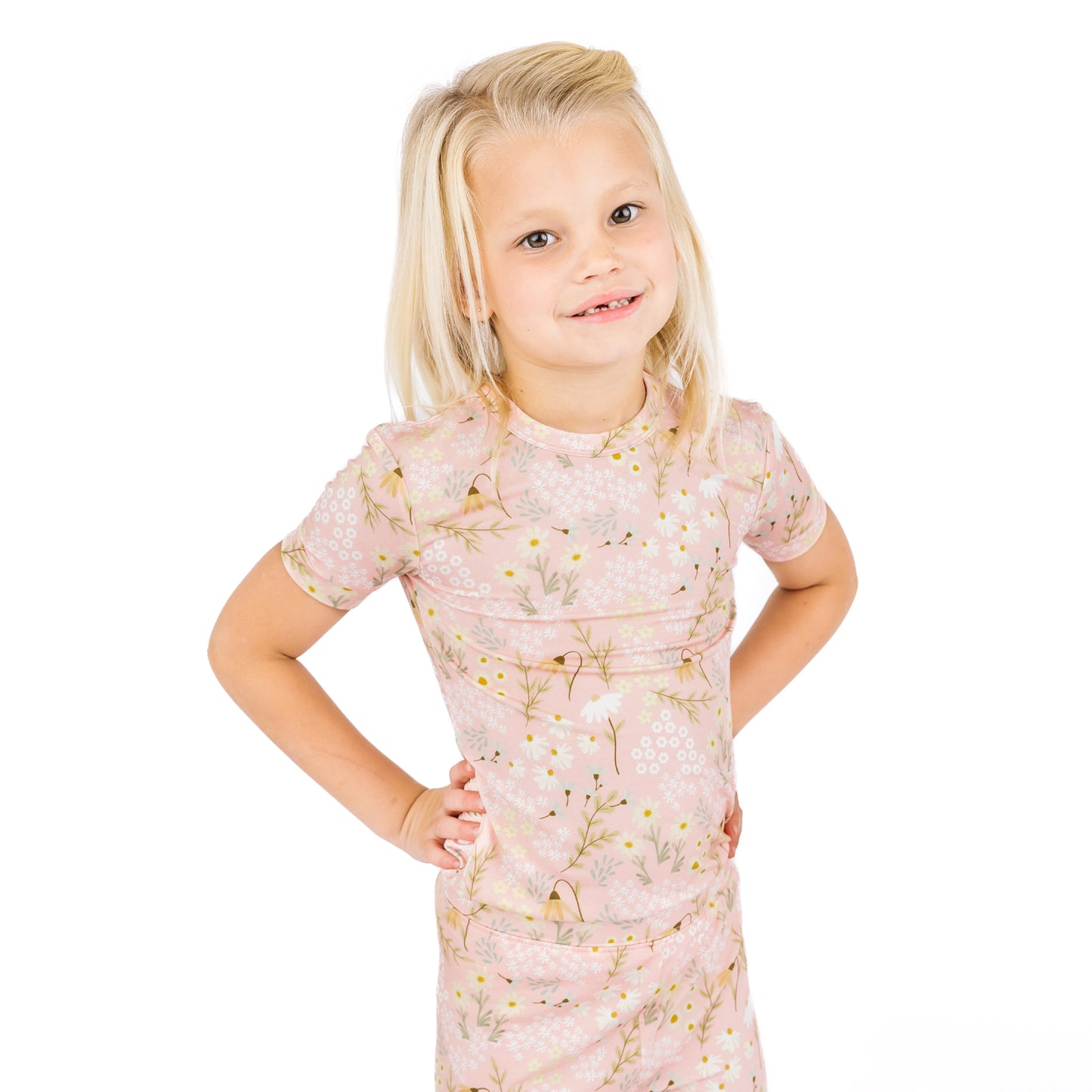 Young girl wearing a floral dress on a white background