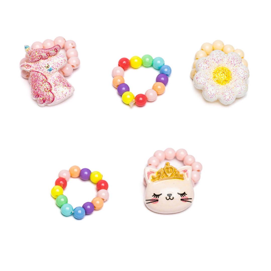 a picture of 5 elastic beaded rings including a pink unicorn head, a daisy, and a pink kitty wearing a crown