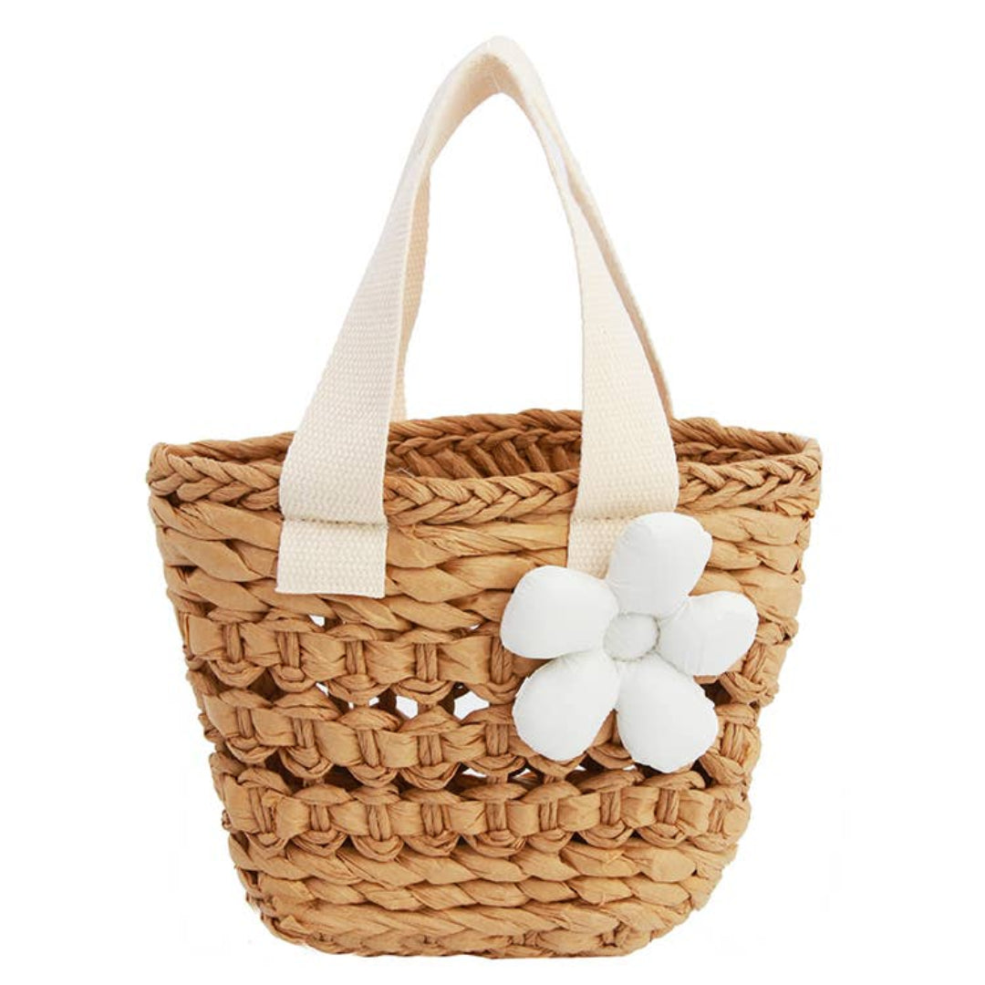 straw tote with a white handle and white flower on the front