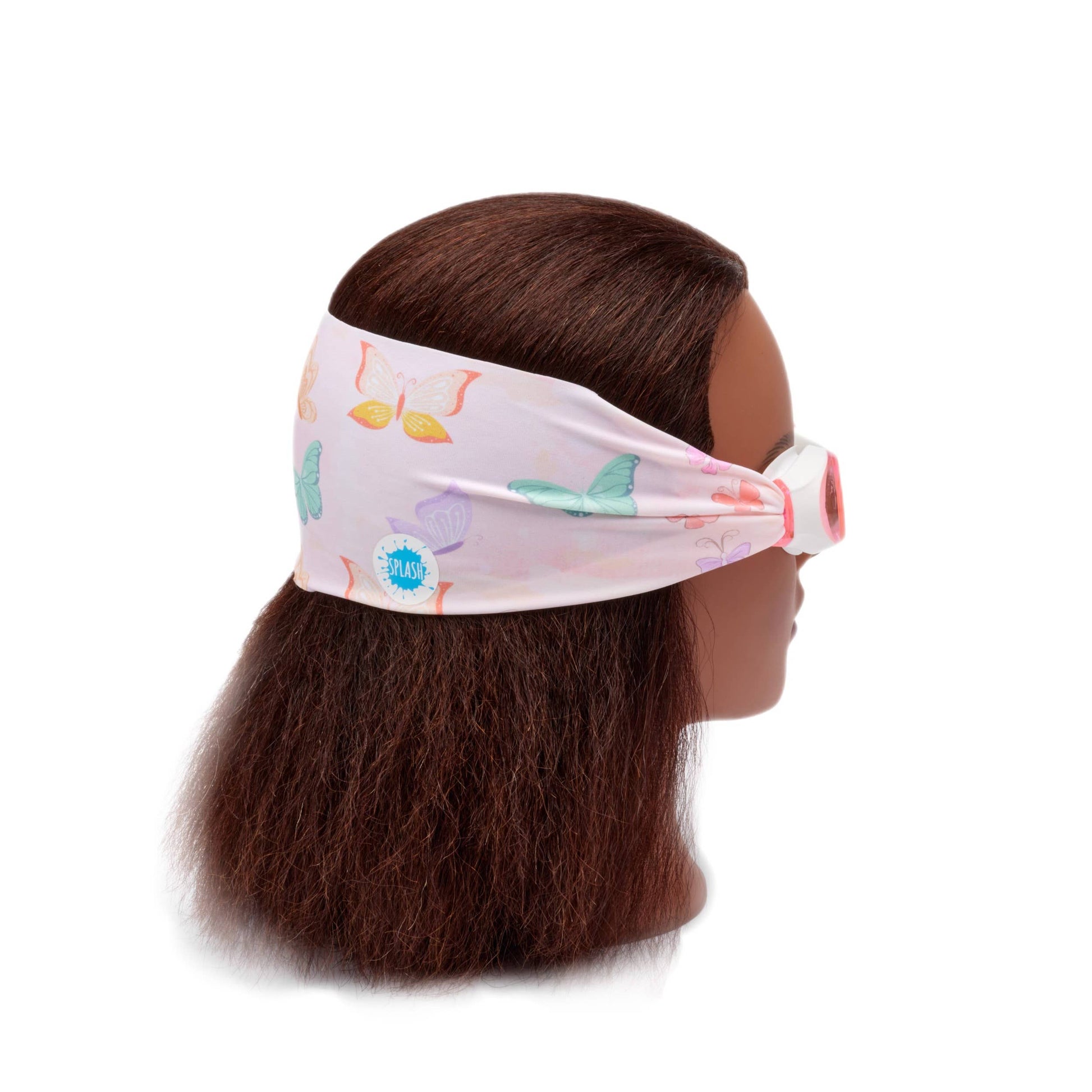 Mannequin head with colorful headband featuring cartoon butterflies on a white background• Splash Place flutter swim goggles with butterfly print fabric strap
• No tangle fabric strap swim goggles with pink tinted lenses and white frame