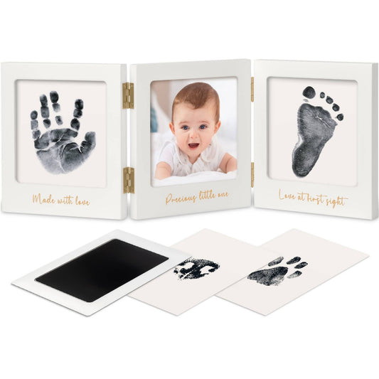White picture frame with inked baby hand and footprints and a picture of a baby