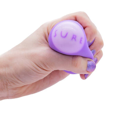 a hand squeezing the squeezy fortune ball and the fortune saying Sure