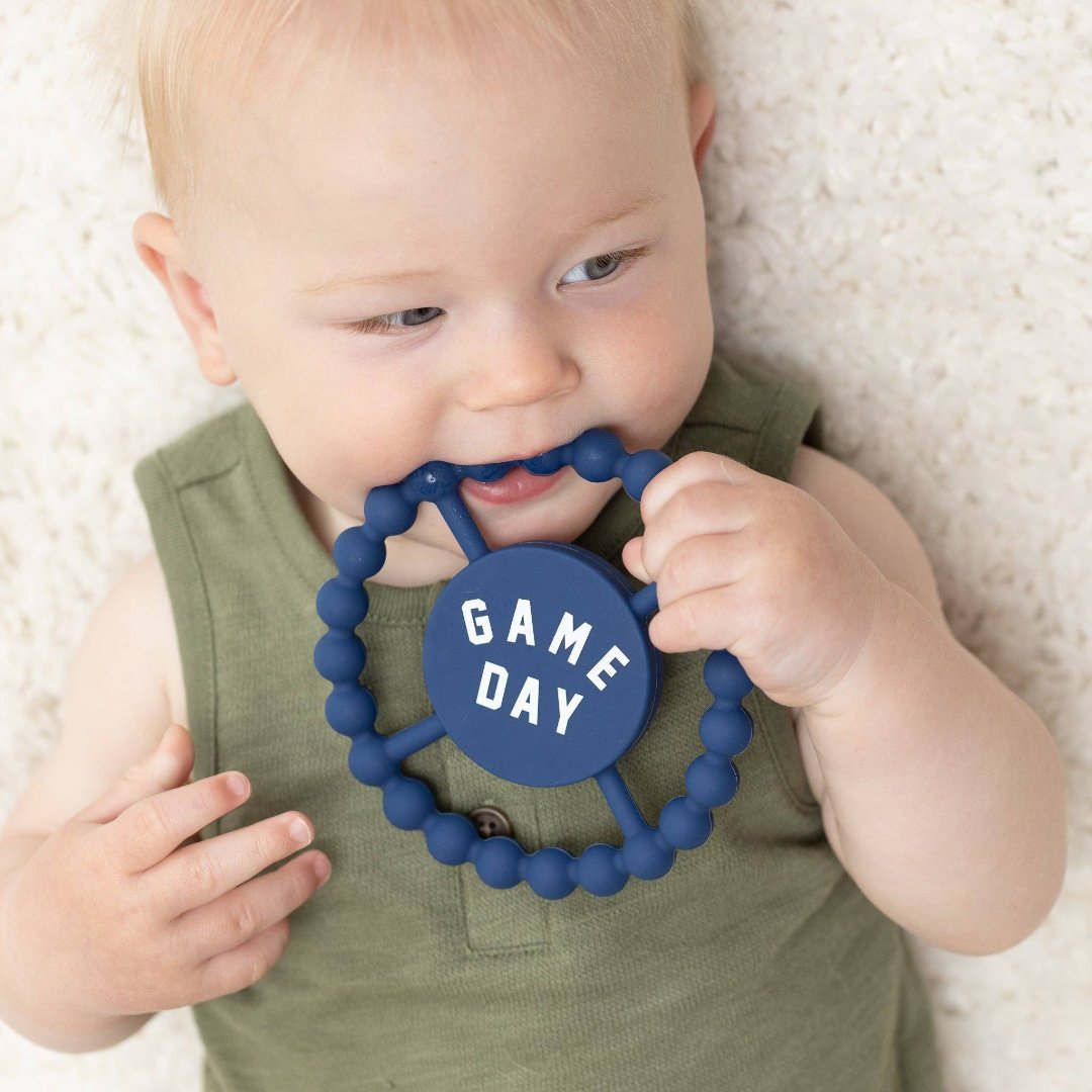 picture of baby with game day teether in mouth