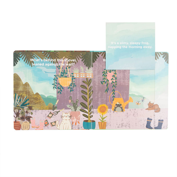 an excerpt from the "Garden Friends"  lift-a-flip board book. - what's behind this shovel, leaned against the wall? it's a slimy, sleepy, frog, napping the morning away. 